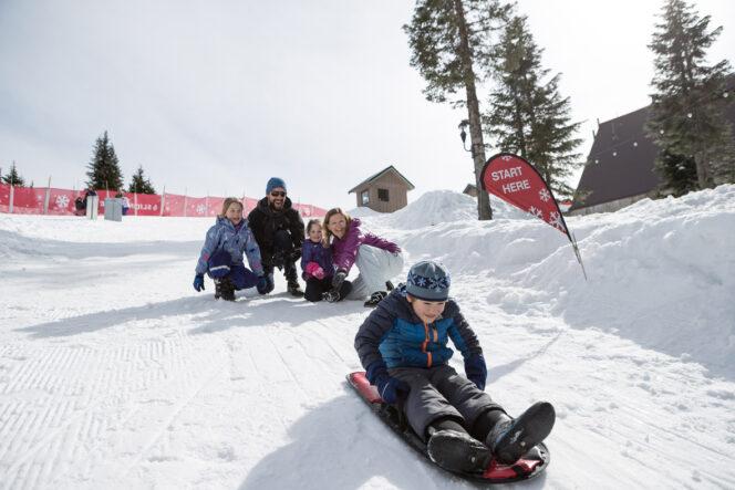 Family sledding at Grouse Mountain in Vancouver